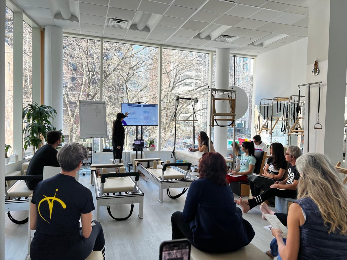 Inelia Garcia in front of a class with a presentation